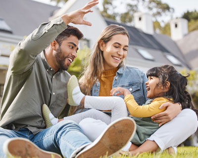 Family Sitting On Grass