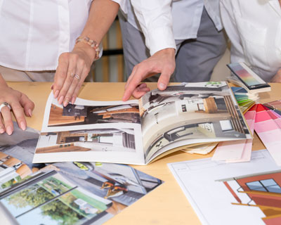People Looking Through Catalog